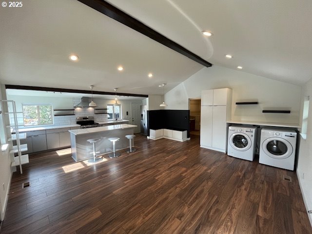 kitchen with separate washer and dryer, dark wood-style floors, white cabinets, stainless steel appliances, and modern cabinets