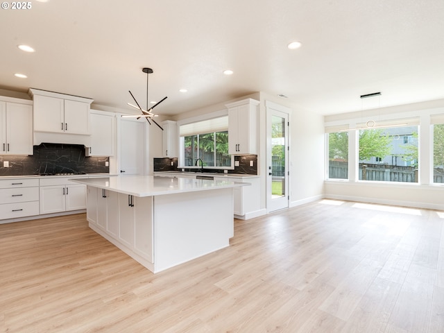 2650 NW Mt Ashland Dr, Mcminnville, OR 97128 - kitchen featuring a kitchen island, backsplash, healthy amount of natural light, light wood-style floors, and recessed lighting