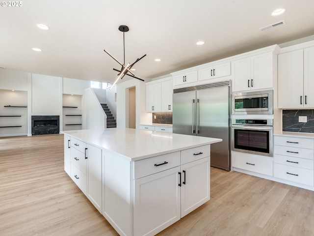2650 NW Mt Ashland Dr, Mcminnville, OR 97128 - kitchen with built in appliances, light wood-type flooring, backsplash, and recessed lighting