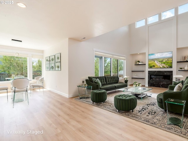 2650 NW Mt Ashland Dr, Mcminnville, OR 97128 - living room featuring wood finished floors, baseboards, a premium fireplace, and a high ceiling