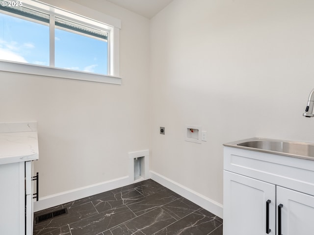 2650 NW Mt Ashland Dr, Mcminnville, OR 97128 - washroom featuring dark marble finish floors, electric dryer hookup, cabinet space, baseboards, and hookup for a washing machine