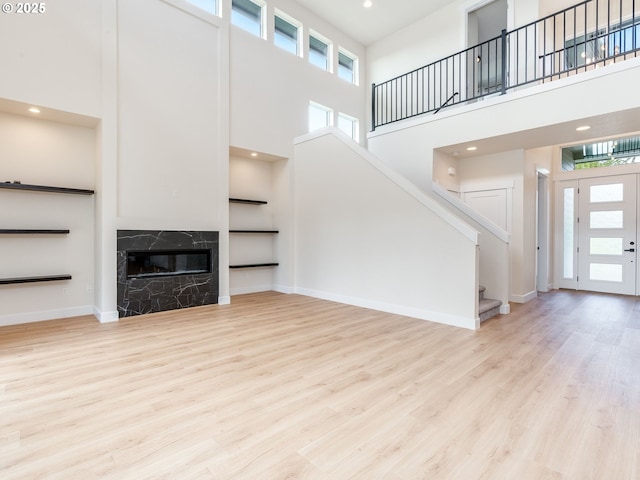 2650 NW Mt Ashland Dr, Mcminnville, OR 97128 - unfurnished living room with a high ceiling, stairway, plenty of natural light, wood finished floors, and recessed lighting
