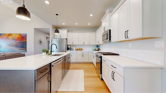 665 Browndell Ln, Stanfield, OR 97875 - kitchen with stainless steel appliances, a sink, light wood-style floors, recessed lighting, and white cabinets