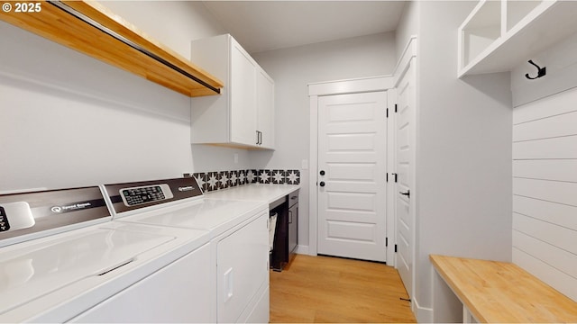 665 Browndell Ln, Stanfield, OR 97875 - laundry area featuring cabinet space, washer and clothes dryer, and light wood finished floors