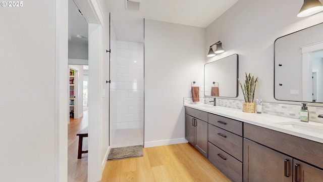 665 Browndell Ln, Stanfield, OR 97875 - full bath featuring wood finished floors, double vanity, backsplash, baseboards, and walk in shower