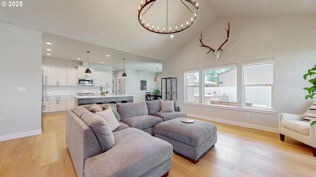 665 Browndell Ln, Stanfield, OR 97875 - living area with a chandelier, light wood-style floors, high vaulted ceiling, baseboards, and recessed lighting
