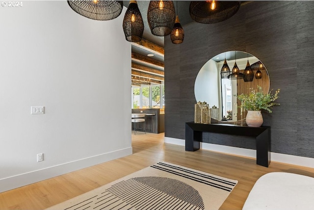 corridor with a high ceiling and light hardwood / wood-style flooring