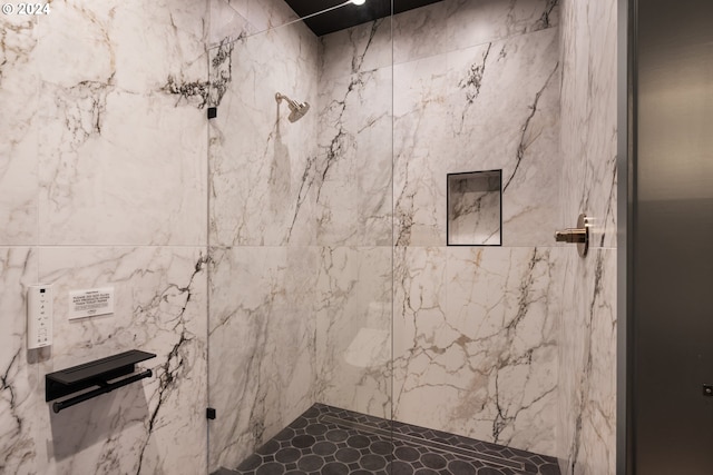 bathroom with a tile shower