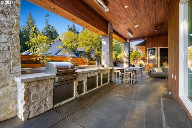 view of patio featuring an outdoor kitchen, sink, and a grill