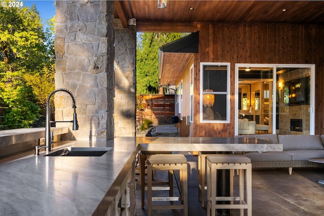 view of patio / terrace with an outdoor hangout area and a wet bar