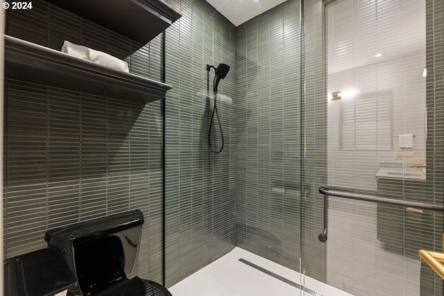 bathroom featuring toilet and an enclosed shower