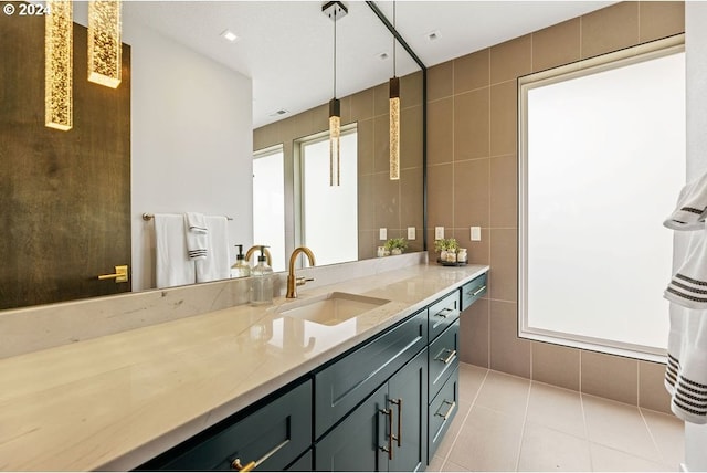 bathroom with tile patterned flooring, tile walls, and vanity