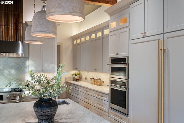 kitchen featuring white cabinets, beamed ceiling, high end appliances, decorative backsplash, and light stone counters