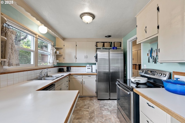 3505 Donald St, Eugene, OR 97405 - kitchen with stainless steel appliances, a sink, open shelves, light countertops, and a textured ceiling