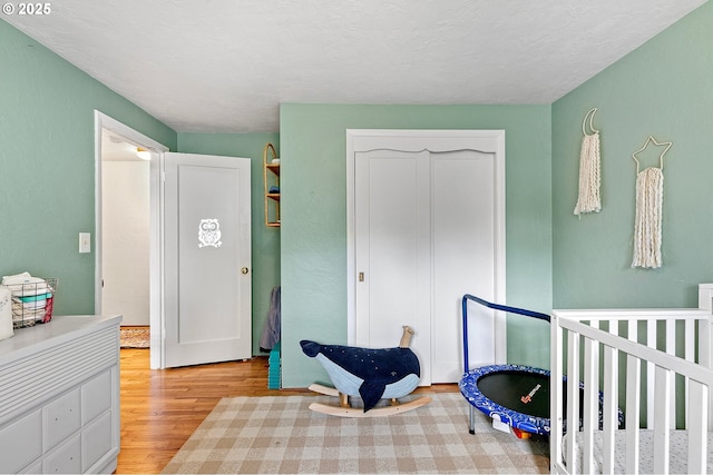 3505 Donald St, Eugene, OR 97405 - bedroom with light wood-style flooring, a closet, and a crib