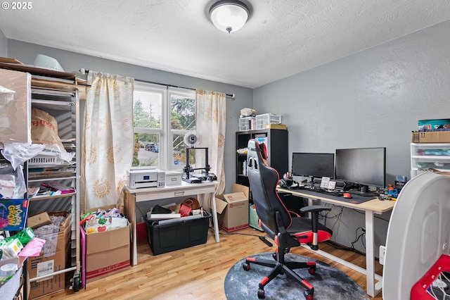 3505 Donald St, Eugene, OR 97405 - home office with wood finished floors, a textured wall, and a textured ceiling