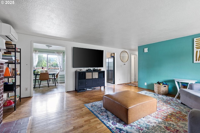 3505 Donald St, Eugene, OR 97405 - living area featuring a textured ceiling, wood finished floors, and a wall mounted air conditioner
