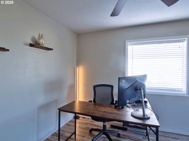 office area featuring ceiling fan, wood finished floors, and baseboards