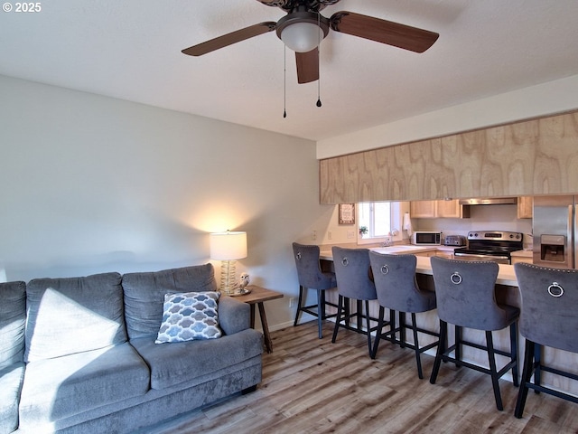 living room with wood finished floors and baseboards