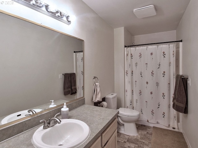 bathroom featuring toilet, curtained shower, and vanity