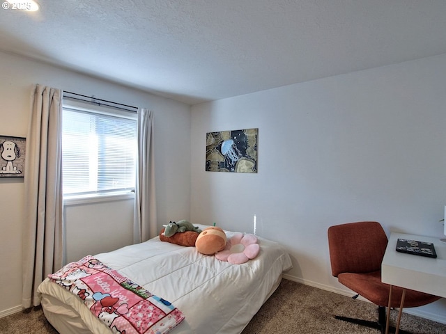 bedroom with a textured ceiling, carpet flooring, and baseboards