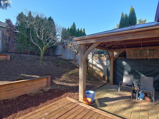 deck featuring a patio, a gazebo, and a fenced backyard