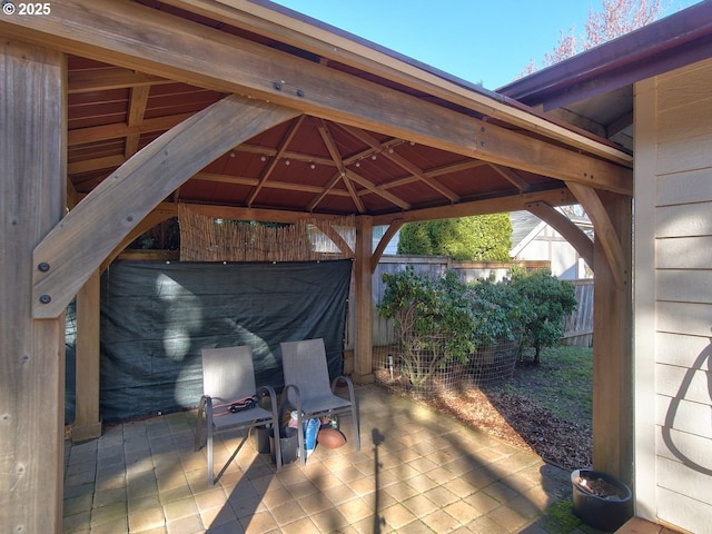 view of patio featuring fence and a gazebo