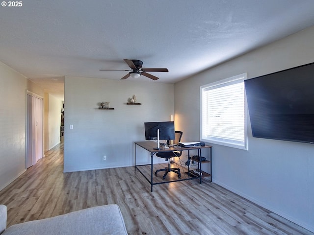 office space featuring a textured ceiling, wood finished floors, a ceiling fan, and baseboards