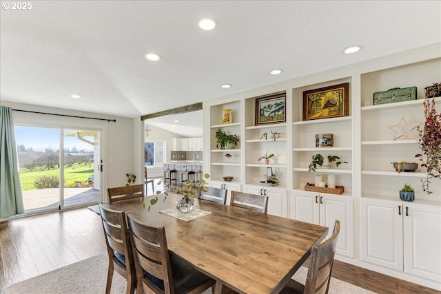 dining area featuring recessed lighting, light wood-type flooring, and a textured ceiling