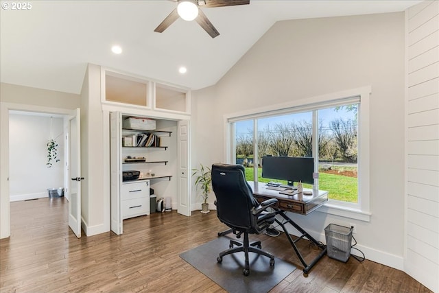 office area with baseboards, wood finished floors, and a ceiling fan