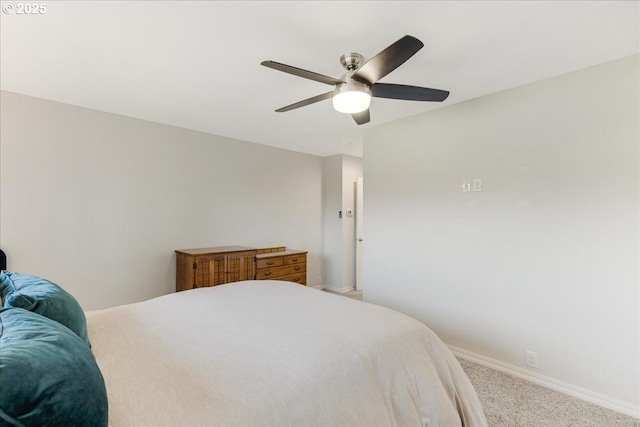 carpeted bedroom with a ceiling fan and baseboards