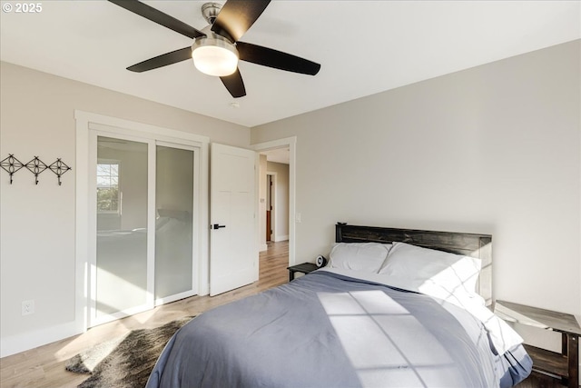 bedroom featuring wood finished floors, baseboards, and ceiling fan