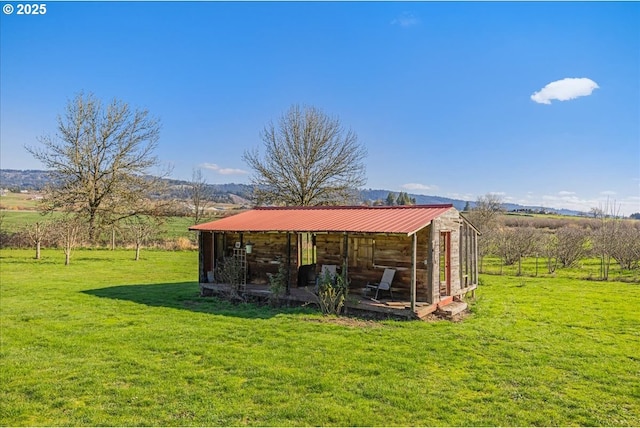 view of yard with an outbuilding and a rural view