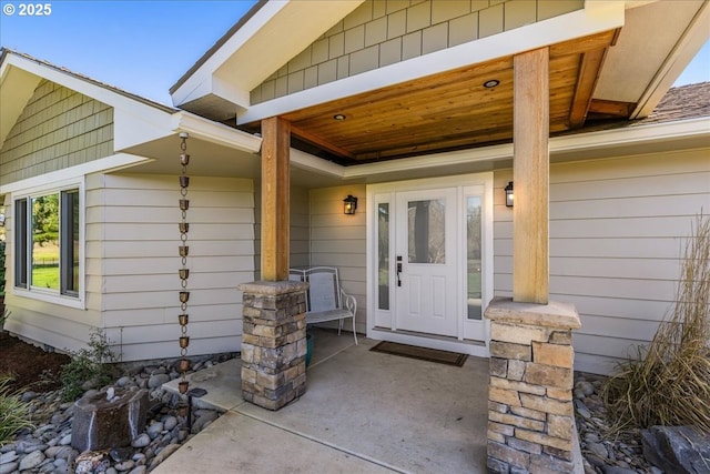 view of exterior entry featuring covered porch