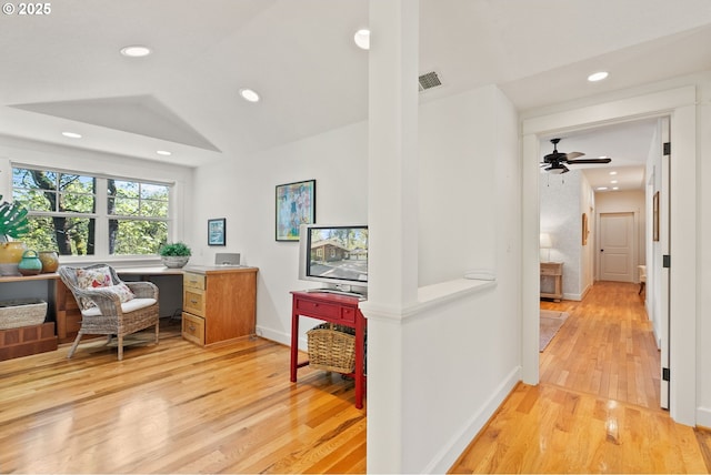 hallway with light wood finished floors, baseboards, visible vents, and recessed lighting