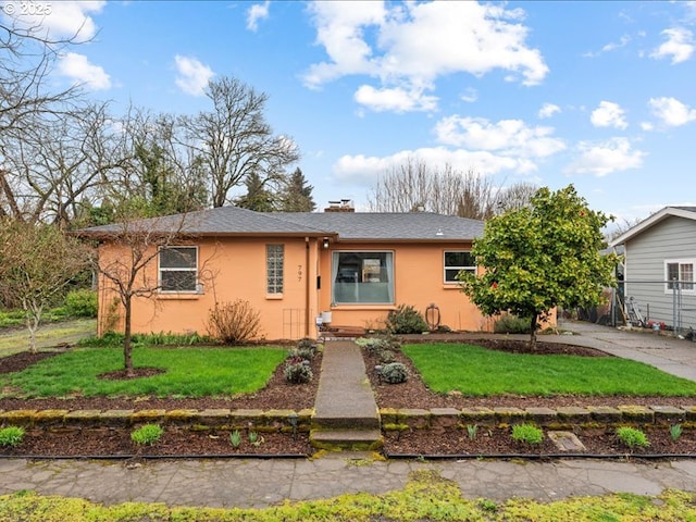 single story home with a front yard, a chimney, roof with shingles, and stucco siding