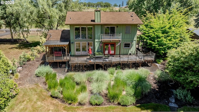390 Singing Waters Rd, Winchester, OR 97495 - rear view of property with french doors, a chimney, board and batten siding, a wooden deck, and a balcony