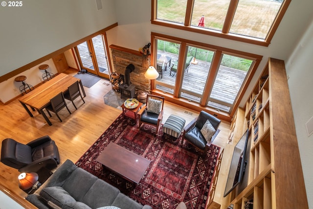390 Singing Waters Rd, Winchester, OR 97495 - living area with a high ceiling, a wood stove, and wood finished floors