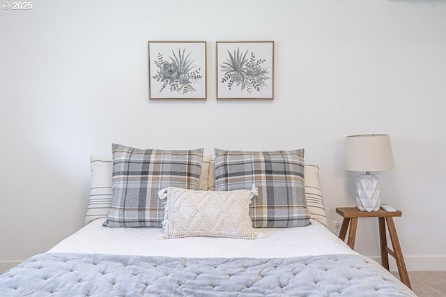 carpeted bedroom featuring baseboards