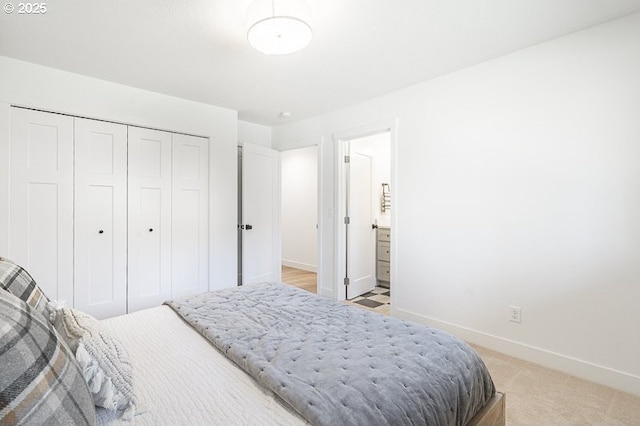 bedroom featuring light carpet, a closet, and baseboards