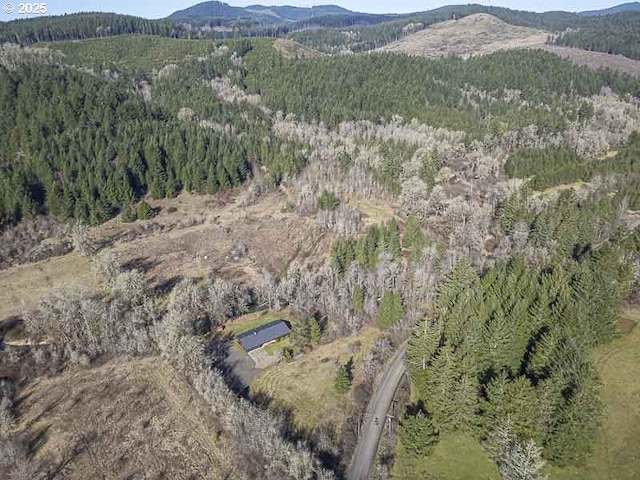 drone / aerial view with a forest view and a mountain view