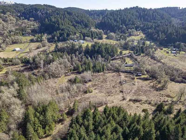 drone / aerial view featuring a forest view