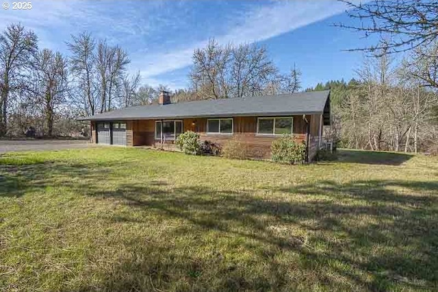 single story home featuring driveway, an attached garage, a chimney, and a front lawn