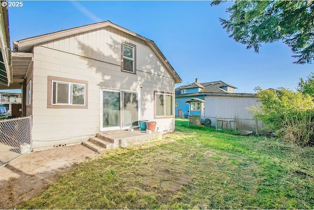 back of house with a yard and fence