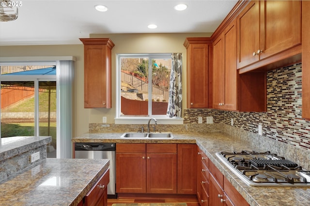 kitchen featuring sink, backsplash, a healthy amount of sunlight, and appliances with stainless steel finishes