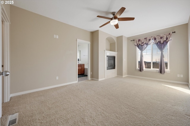 unfurnished living room with light carpet and ceiling fan