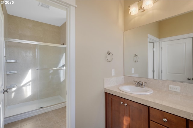 bathroom featuring tile patterned floors, vanity, and a shower with door