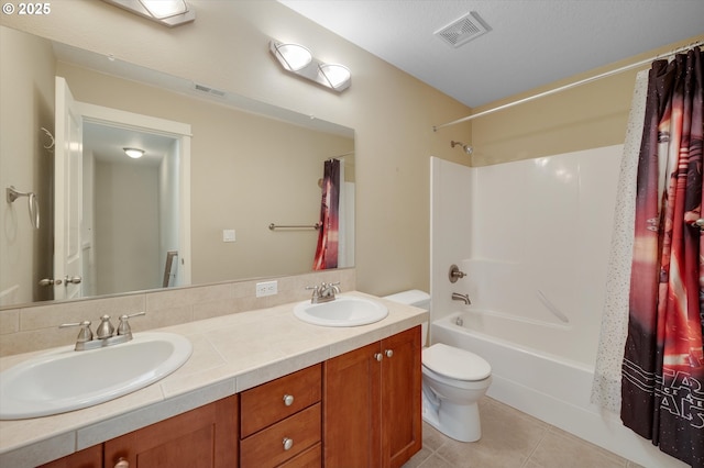 full bathroom with tile patterned flooring, vanity, shower / tub combo, and toilet