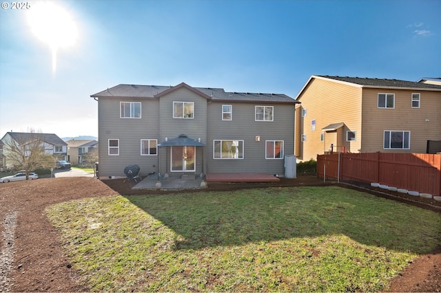 rear view of property with a lawn and a patio