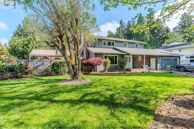 view of front of home with brick siding, a garage, fence, and a front yard